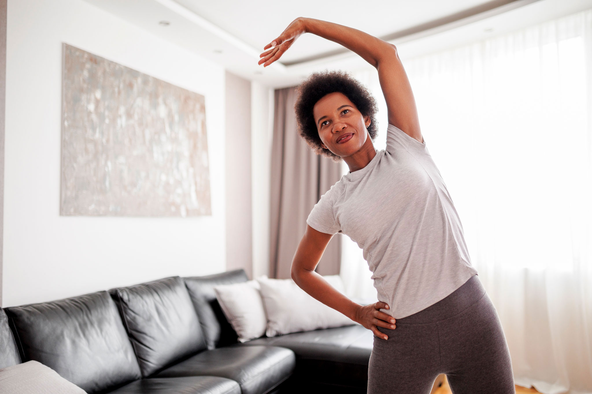 Fit woman doing warm up exercise during home workout